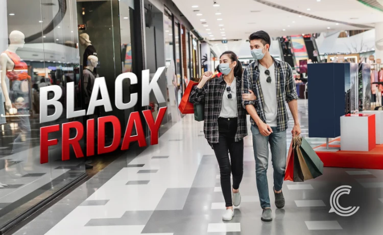 Shoppers browsing discounted products during Black Friday as footfall declines.